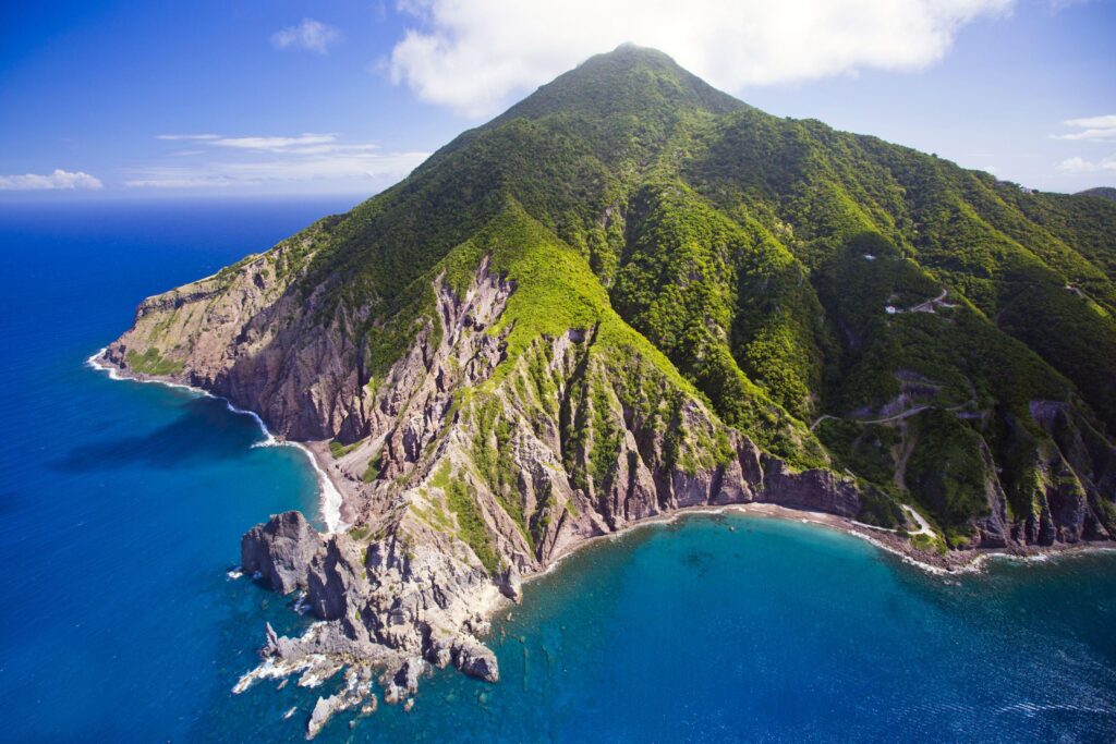 Volcanic island of Saba rising steeply from the Caribbean Sea