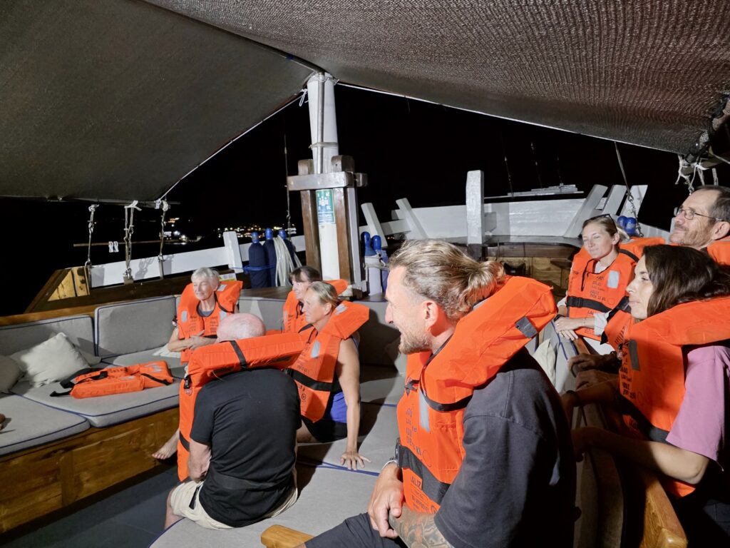 Divers wearing life jackets during a muster drill onboard a liveaboard
