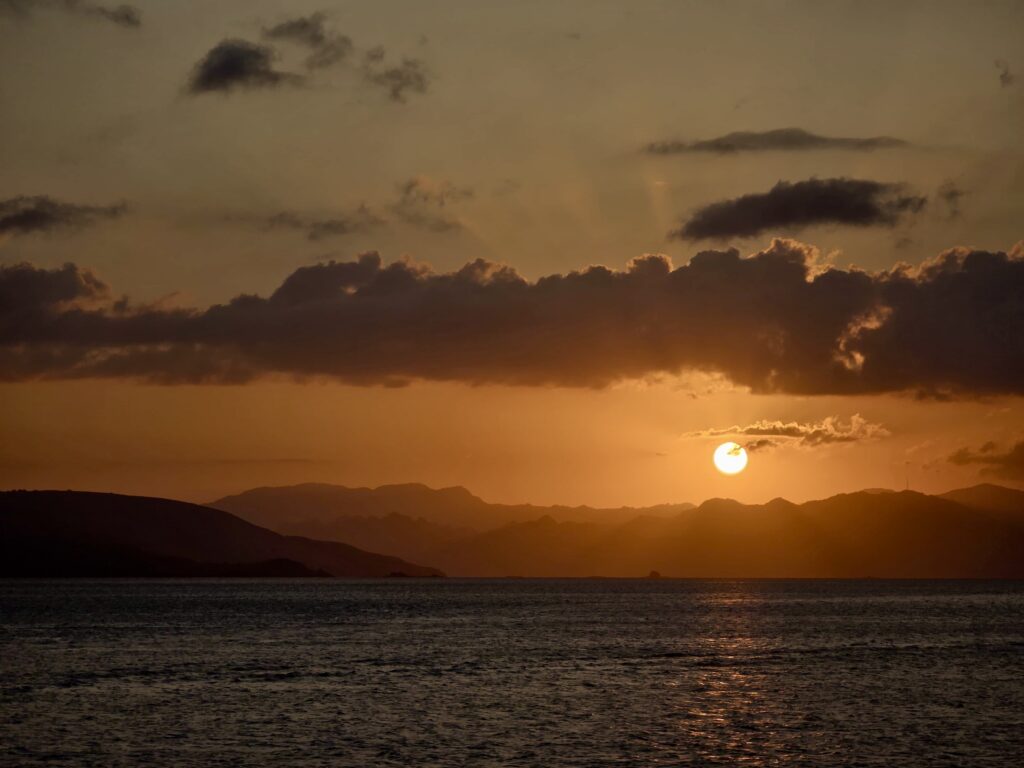 Sunset over the islands of Komodo National Park viewed from a liveaboard